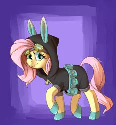 Size: 1200x1300 | Tagged: safe, artist:passigcamel, derpibooru import, fluttershy, pony, belt, bunny ears, clothes, costume, dangerous mission outfit, female, goggles, hoodie, looking at you, mare, raised hoof, smiling, solo, utility belt