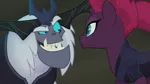 Size: 1777x1000 | Tagged: safe, derpibooru import, screencap, storm king, tempest shadow, pony, my little pony: the movie, broken horn, duo, fangs, female, looking at each other, male, mare, raised eyebrow, sharp teeth, smiling, teeth