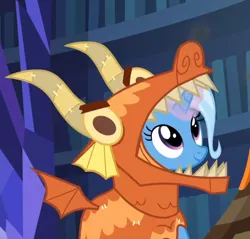 Size: 702x672 | Tagged: safe, derpibooru import, screencap, trixie, pony, unicorn, uncommon bond, board game, clothes, costume, cute, diatrixes, dragon costume, dragon pit, female, glowing horn, looking up, mare, smiling, solo