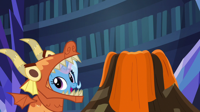 Size: 640x360 | Tagged: safe, derpibooru import, screencap, trixie, pony, unicorn, uncommon bond, clothes, costume, cute, dragon costume, female, glowing horn, mare, open mouth, smiling, solo