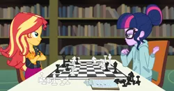 Size: 1426x755 | Tagged: safe, derpibooru import, screencap, sci-twi, sunset shimmer, twilight sparkle, equestria girls, equestria girls series, the finals countdown, chair, chess, chessboard incorrectly oriented, clothes, crossed arms, cute, jacket, leather jacket, pants, sitting, smiling, smirk, vest