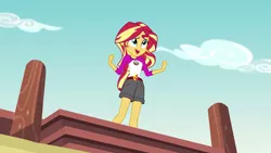 Size: 1280x720 | Tagged: safe, derpibooru import, screencap, sunset shimmer, equestria girls, legend of everfree, camp everfree outfits, clothes, embrace the magic, female, open mouth, pier, shorts, singing, solo