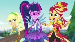 Size: 1280x720 | Tagged: safe, derpibooru import, screencap, applejack, sci-twi, sunset shimmer, twilight sparkle, equestria girls, legend of everfree, alternate hairstyle, clothes, crystal guardian, crystal wings, gloves, log, open mouth, pants, super strength