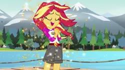 Size: 1280x720 | Tagged: safe, derpibooru import, screencap, sunset shimmer, equestria girls, legend of everfree, camp everfree outfits, clothes, embrace the magic, eyes closed, female, forest, lake, open mouth, scenery, shorts, singing, solo, sparkles, tree, water