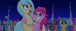 Size: 1920x804 | Tagged: safe, derpibooru import, screencap, bell perin, pinkie pie, princess skystar, unnamed pony, classical hippogriff, earth pony, hippogriff, pony, my little pony: the movie, background pony, female, flower, hug, jewelry, male, mare, necklace, rainbow (song), seashell, seashell necklace, smiling, stallion, winghug
