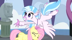 Size: 1920x1080 | Tagged: safe, derpibooru import, screencap, fluttershy, silverstream, classical hippogriff, hippogriff, pegasus, pony, school daze, season 8, colored hooves, duo, female, grin, jewelry, mare, necklace, outstretched arm, smiling