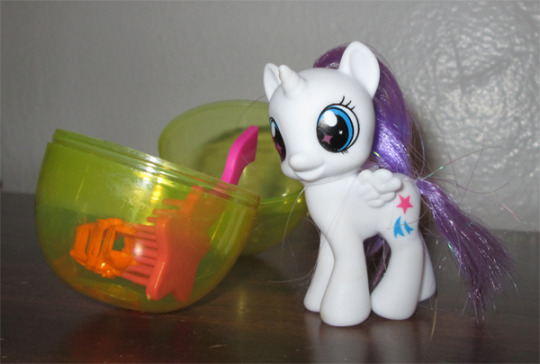 Size: 540x364 | Tagged: safe, derpibooru import, glory, alicorn, pony, bootleg, brush, egg, female, filly, irl, photo, solo, toy