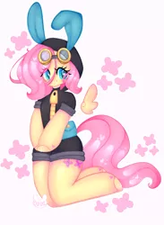 Size: 2483x3400 | Tagged: safe, artist:bunxl, derpibooru import, fluttershy, pegasus, pony, semi-anthro, anatomically incorrect, blushing, bunny ears, clothes, colored pupils, costume, cute, cutie mark background, dangerous mission outfit, female, goggles, heart, heart eyes, hoodie, incorrect leg anatomy, kneeling, looking at you, mare, signature, simple background, smiling, solo, white background, wingding eyes