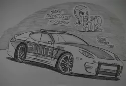 Size: 1909x1296 | Tagged: safe, artist:ricky47, derpibooru import, fluttershy, butterfly, pegasus, pony, car, crossover, female, monochrome, need for speed, need for speed: hot pursuit, police, police car, police officer, porsche, porsche panamera, sketch, solo, traditional art