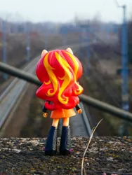 Size: 1024x1365 | Tagged: safe, artist:artofmagicpoland, derpibooru import, sunset shimmer, equestria girls, boots, clothes, doll, equestria girls minis, hair, irl, jacket, photo, ponied up, railroad, shoes, skirt, toy