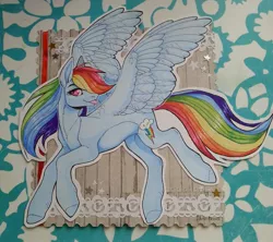 Size: 1280x1136 | Tagged: safe, artist:dark-fox01, derpibooru import, rainbow dash, pegasus, pony, card, craft, cutie mark, female, flying, looking at you, mare, papercraft, solo, spread wings, tongue out, traditional art, wings