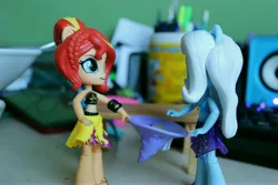 Size: 6000x4000 | Tagged: safe, artist:artofmagicpoland, derpibooru import, sunset shimmer, trixie, equestria girls, equestria girls series, clothes, doll, equestria girls minis, female, hat, holding, lesbian, shipping, suntrix, toy, trixie's hat