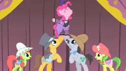 Size: 1280x720 | Tagged: apple family member, apple fritter, caramel, clothes, costume, derpibooru import, eyes closed, lifting, lucky clover, over a barrel, peachy sweet, pinkie pie, safe, saloon pinkie, screencap, singing, stage, you gotta share