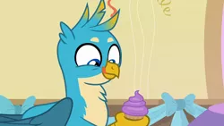 Size: 1280x720 | Tagged: safe, derpibooru import, screencap, gallus, gryphon, marks for effort, cupcake, cute, dessert, food, gallabetes, licking, licking lips, male, smiling, solo, teenager, tongue out