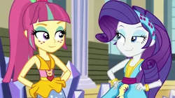 Size: 1912x1072 | Tagged: safe, derpibooru import, screencap, rarity, sour sweet, dance magic, equestria girls, spoiler:eqg specials, :j, canterlot high, clothes, dress, duo, female, freckles, hand on hip, headband, lidded eyes, ponytail, skirt, smiling, teletoon