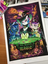 Size: 1536x2048 | Tagged: safe, artist:andypriceart, derpibooru import, idw, princess cadance, princess celestia, princess luna, alicorn, cat, pony, spoiler:comic, spoiler:comic71, andy you magnificent bastard, bedroom eyes, candle, cauldron, clothes, do you believe in magic?, female, halloween, hat, holiday, hood, ironic, jack-o-lantern, looking at you, mare, nightmare night, photo, pumpkin, skull, staff, trio, witch, witch hat