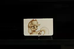 Size: 1280x853 | Tagged: safe, artist:horseez, derpibooru import, applejack, earth pony, pony, box, female, looking back, mare, pyrography, solo, traditional art