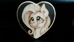 Size: 5312x2988 | Tagged: safe, artist:horseez, derpibooru import, fluttershy, pegasus, pony, bust, chest fluff, female, heart, mare, portrait, pyrography, smiling, solo, traditional art