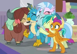 Size: 647x455 | Tagged: safe, derpibooru import, screencap, gallus, ocellus, sandbar, silverstream, smolder, yona, changedling, changeling, classical hippogriff, dragon, earth pony, gryphon, hippogriff, pony, yak, the hearth's warming club, bow, cloven hooves, cute, diaocelles, diastreamies, dragoness, female, gallabetes, group hug, hair bow, hug, jewelry, male, monkey swings, necklace, sandabetes, smolderbetes, student six, teenager, yonadorable