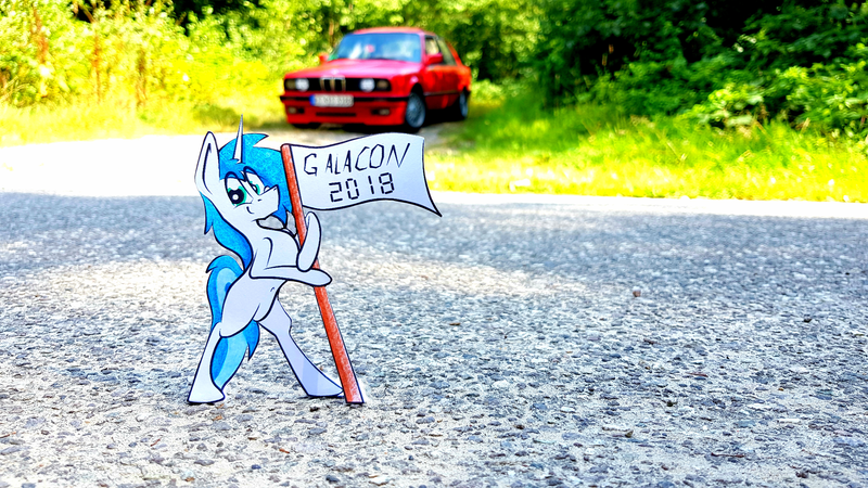 Size: 4032x2268 | Tagged: safe, artist:bumskuchen, derpibooru import, oc, oc:shifting gear, pony, unicorn, bmw, car, galacon, galacon 2018, irl, photo, real life background, solo, traditional art, vehicle