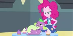 Size: 1315x640 | Tagged: safe, derpibooru import, screencap, pinkie pie, spike, spike the regular dog, dog, equestria girls, friendship games, cupcake, fat, fat spike, food, friendship games bloopers, gluttony, needs more jpeg, pinkie pie is not amused, puppy, raised eyebrow, stuffed, unamused