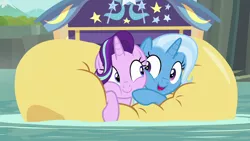 Size: 1280x720 | Tagged: safe, derpibooru import, screencap, starlight glimmer, trixie, pony, unicorn, road to friendship, cheek squish, cheek to cheek, cute, diatrixes, duo, female, friendshipping, ghastly gorge, glimmerbetes, i guess we're stuck together, inflatable, inflatable raft, mare, prone, raft, shipping fuel, smiling, snuggling, squished, squishy, squishy cheeks, we're friendship bound