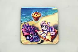 Size: 1024x683 | Tagged: safe, artist:art-n-prints, derpibooru import, princess celestia, princess luna, alicorn, pony, beach, cewestia, coaster, cute, cutelestia, female, filly, food, lunabetes, magic, muffin, pillow, pink-mane celestia, royal sisters, siblings, sisters, smiling, weapons-grade cute, woona, younger