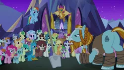 Size: 1280x720 | Tagged: safe, derpibooru import, screencap, applejack, fluttershy, gallus, ocellus, pinkie pie, rainbow dash, rarity, rockhoof, sandbar, silverstream, smolder, spike, summer breeze, twilight sparkle, twilight sparkle (alicorn), yona, alicorn, changedling, changeling, classical hippogriff, dragon, earth pony, gryphon, hippogriff, pegasus, pony, yak, a rockhoof and a hard place, audience, beard, bow, braid, clothes, cloven hooves, dragoness, facial hair, female, flying, friendship student, hair bow, hair bun, hoof wraps, jewelry, male, mane six, mare, monkey swings, moustache, necklace, rockhoof's shovel, shovel, stallion, student six, wall of tags
