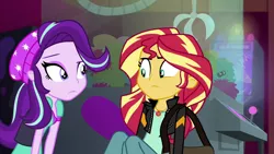 Size: 1920x1080 | Tagged: safe, derpibooru import, screencap, starlight glimmer, sunset shimmer, equestria girls, mirror magic, spoiler:eqg specials, beanie, claw machine, female, hat, looking at each other, messenger bag