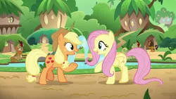 Size: 1280x720 | Tagged: safe, derpibooru import, screencap, applejack, fern flare, fluttershy, forest fall, pumpkin smoke, earth pony, kirin, pegasus, pony, sounds of silence, background kirin, bucket, duo focus, female, fountain, kirin village, male, mare, raised hoof