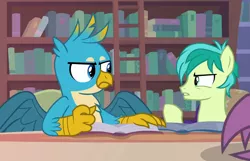 Size: 1118x720 | Tagged: safe, derpibooru import, screencap, gallus, sandbar, silverstream, earth pony, gryphon, pony, what lies beneath, book, bookshelf, chest fluff, claws, ladder, library, male, upset, wings