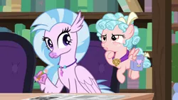 Size: 1280x720 | Tagged: safe, derpibooru import, screencap, cozy glow, silverstream, classical hippogriff, hippogriff, pegasus, pony, school raze, bag, book, bookshelf, cozy glow is not amused, duo, female, filly, flying, foal, jewelry, necklace, pencil, saddle bag