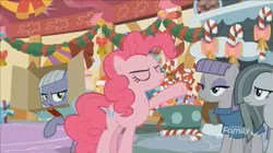 Size: 1351x757 | Tagged: safe, derpibooru import, screencap, limestone pie, marble pie, maud pie, pinkie pie, earth pony, pony, best gift ever, bow, box, candy, candy cane, decoration, discovery family logo, eyes closed, female, food, lollipop, mare, pie sisters, raised hoof, siblings, sisters, sugarcube corner