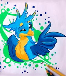 Size: 1465x1681 | Tagged: safe, artist:emberslament, derpibooru import, gallus, gryphon, cheek fluff, chest fluff, colored pencil drawing, colored pencils, cute, gallabetes, happy, looking at you, male, one eye closed, pencil, photo, quadrupedal, simple background, smiling, solo, traditional art, wing gesture, wing hands, wings, wink