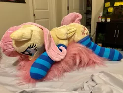 Size: 1422x1067 | Tagged: safe, artist:dawning love, artist:natureshy, derpibooru import, fluttershy, pony, clothes, head down, heart eyes, irl, lying down, photo, plushie, socks, solo, striped socks, wingding eyes