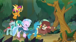 Size: 1366x768 | Tagged: safe, derpibooru import, gallus, ocellus, sandbar, silverstream, smolder, yona, changedling, changeling, classical hippogriff, dragon, earth pony, gryphon, hippogriff, pony, yak, non-compete clause, bow, cloven hooves, colored hooves, dragoness, female, flying, forest, gesture, hair bow, jewelry, male, monkey swings, necklace, raised hoof, student six, teenager, tree