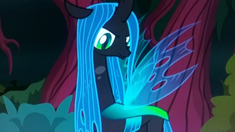Size: 2560x1440 | Tagged: changeling, changeling queen, derpibooru import, female, looking at you, photo, picture of a screen, queen chrysalis, safe, screencap, solo, the mean 6