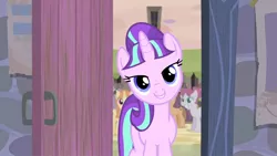 Size: 1920x1080 | Tagged: safe, derpibooru import, screencap, starlight glimmer, pony, unicorn, the cutie re-mark, door, female, lidded eyes, looking at you, mare, our town, rosemary, s5 starlight, smiling, solo focus