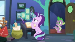 Size: 2048x1144 | Tagged: safe, derpibooru import, screencap, spike, starlight glimmer, dragon, pony, unicorn, every little thing she does, book, desk, female, inkwell, kite, magic, male, mare, quill, starlight's room, telekinesis