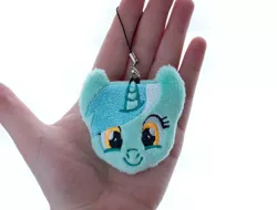 Size: 1314x1000 | Tagged: safe, artist:meplushyou, derpibooru import, lyra heartstrings, human, pony, unicorn, charm, female, hand, irl, irl human, looking at you, mare, photo, plushie, smiling