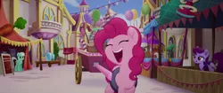 Size: 1920x804 | Tagged: safe, derpibooru import, screencap, mochaccino, pinkie pie, rare find, unnamed character, unnamed pony, earth pony, pony, unicorn, my little pony: the movie, background pony, canterlot, canterlot shopkeep, cart, eyes closed, female, friendship festival, mare, market, singing, we got this together