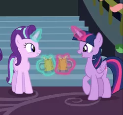 Size: 914x851 | Tagged: safe, derpibooru import, screencap, starlight glimmer, twilight sparkle, twilight sparkle (alicorn), alicorn, pony, unicorn, a hearth's warming tail, cider, cropped, cup, cute, female, glimmerbetes, glowing horn, happy, horn, levitation, looking at each other, magic, mare, open mouth, raised hoof, smiling, stairs, tankard, telekinesis, twiabetes