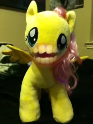 Size: 1080x1440 | Tagged: safe, derpibooru import, editor:kw studio, fluttershy, pegasus, pony, bedroom, cursed image, disturbing, explicit source, female, horrifying, human mouth, irl, mare, nightmare fuel, photo, plushie, pony thread simulator, screaming, shitposting, stuffed with pleasure: lick it..., terrifying, wat, wtf, youtube screencap