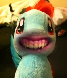 Size: 1080x1245 | Tagged: safe, derpibooru import, editor:kw studio, rainbow dash, pegasus, pony, bedroom, creepy, creepy smile, cursed image, disturbing, explicit source, female, horrifying, human mouth, irl, mare, nightmare fuel, photo, plushie, pony thread simulator, shitposting, smiling, stuffed with pleasure: lick it..., synchrovox, terrifying, wat, what has science done, wtf, youtube screencap