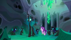 Size: 1440x809 | Tagged: safe, derpibooru import, screencap, queen chrysalis, starlight glimmer, thorax, changeling, changeling queen, pony, unicorn, to where and back again, armor, changeling guard, changeling hive, changeling slime, cocoon, disguise, disguised changeling, fake starlight glimmer, female, helmet, mare