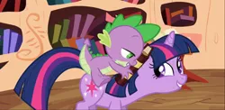 Size: 1666x816 | Tagged: safe, derpibooru import, screencap, spike, twilight sparkle, dragon, pony, unicorn, the cutie pox, book, cropped, dragons riding ponies, duo, female, golden oaks library, lidded eyes, male, mare, out of context, riding, smiling, unicorn twilight