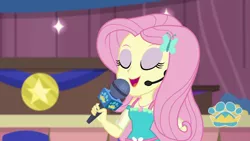 Size: 1280x720 | Tagged: safe, derpibooru import, screencap, fluttershy, best in show: the victory lap, equestria girls, equestria girls series, spoiler:eqg series (season 2), eyes closed, eyeshadow, makeup, microphone, open mouth, smiling, solo