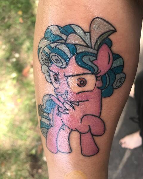 Size: 1080x1350 | Tagged: safe, derpibooru import, cozy glow, human, pegasus, pony, evil, evil grin, female, filly, grin, irl, irl human, photo, pure concentrated unfiltered evil of the utmost potency, pure unfiltered evil, raised hoof, smiling, tattoo