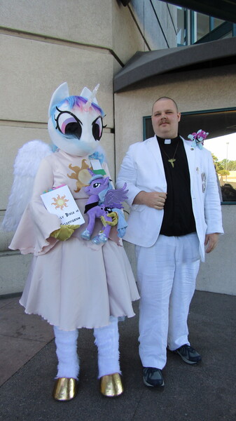 Size: 2896x5152 | Tagged: safe, derpibooru import, princess celestia, princess luna, human, babscon 2019, book, celestianism, fursuit, irl, photo, plushie, priest