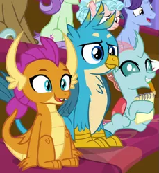 Size: 613x670 | Tagged: safe, derpibooru import, screencap, clever musings, cozy glow, gallus, november rain, ocellus, smolder, violet twirl, changedling, changeling, dragon, gryphon, pegasus, pony, unicorn, a matter of principals, chest feathers, chest fluff, classroom, claws, cropped, curly hair, curved horn, cute, diaocelles, dragoness, eager, excited, fangs, female, filly, folded wings, friendship student, gallabetes, horn, horns, male, notebook, open mouth, pencil, pencil in mouth, school of friendship, sitting, slit eyes, smolderbetes, talons, teenaged dragon, teenager, wings